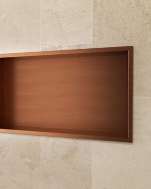Nicho para duche Pacific 63x33cm em aço inox com acabamento PVD Ouro Rosa Escovado instalado na parede.